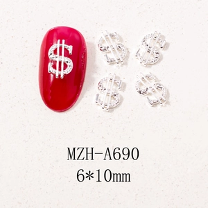 Macro view of silver dollar sign nail charms with crystals on red manicure nails
