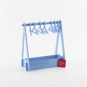 Detailed view of light blue acrylic earring rack with mini hangers and storage base