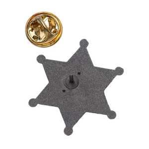 Macro view of vintage star badge back with metal pin and gold butterfly clutch fastener