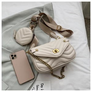 Detail of beige V-quilted crossbody bag with gold hardware and mini coin purse