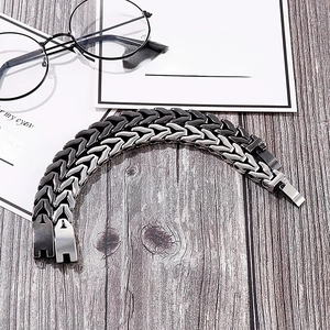 Detail view of retro steel dragon bone bracelets with matte black and silver finishes