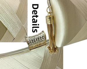 Macro details of champagne evening clutch with pleated fabric, tassel, and rhinestone clasp