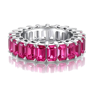 Detailed macro view of eternity ring with pink baguette-cut gems and silver plating