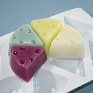 Detailed view of 8-cavity silicone mold featuring colorful cheese-shaped mousse cakes