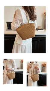 Close-up of khaki tote bag with vertical pleated texture and elegant gold hardware