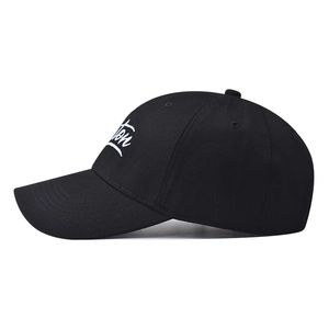 Close-up of white script Boston embroidery on a black cotton twill baseball cap fabric