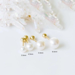 Detail of four different pearl stud earring sizes ranging from 3.5mm to 6.5mm with gold screws