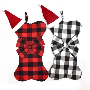 Dog bone shaped Christmas stockings in red and black plaid with festive bow decorations