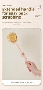 Close-up of long-handled bath brush featuring soft bristles and a dual-sided foaming mesh