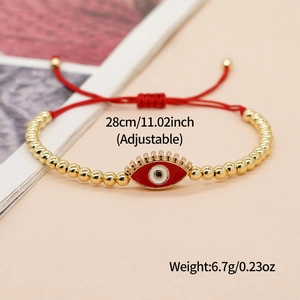 Adjustable 28cm red evil eye bracelet with 4mm gold beads weighing 6.7g on magazine
