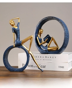 Detail of Nordic resin yoga goddess statues with gold and blue matte finish textures