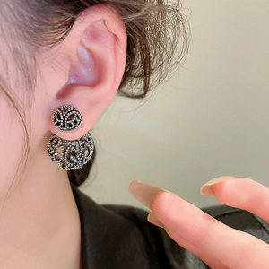 Vintage hollow geometric silver post earrings with double-sided metal balls on model