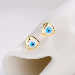 18K gold plated triangle stud earrings with blue evil eye enamel on white display