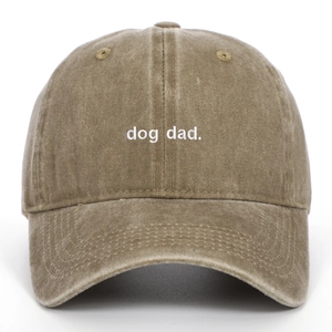 Close-up of dog dad embroidery on washed cotton baseball cap with textured finish