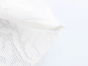 Nahaufnahme von weißem Stricknetzgewebe mit detaillierter Naht und transparenter Textur