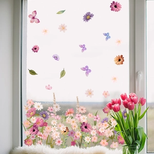 Detail showing watercolor flower and butterfly window stickers on glass surface