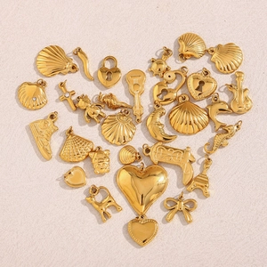 Assortment of gold-plated stainless steel charms including guitar and Eiffel Tower shapes