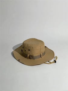 Detail view of khaki boonie hat with breathable metal eyelets and adjustable chin strap