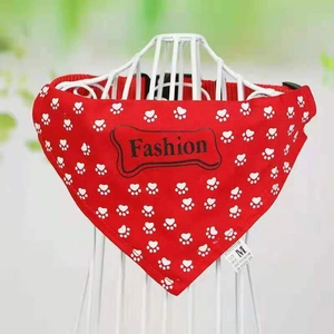 Detail of red pet bandana with white paw prints and fashion bone design in size M