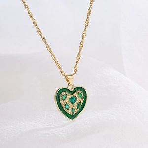 Classic 18K gold plated heart pendant necklace with green zircons on white fabric