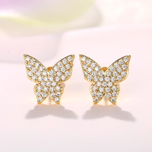 Close-up of gold-plated butterfly stud earrings with micro-pave cubic zirconia crystals