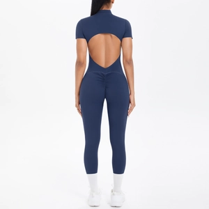 Short sleeve navy yoga jumpsuit featuring an open back and ruched back detailing