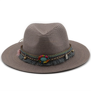 Detail of woven straw fedora featuring ethnic beaded band with turquoise and tassel