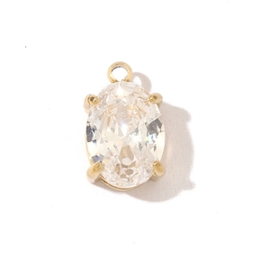 Detailed view of an oval transparent gemstone pendant with a gold stainless steel frame