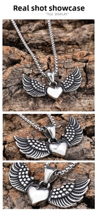 Macro detail of vintage gothic wing and heart pendant in silver-tone stainless steel