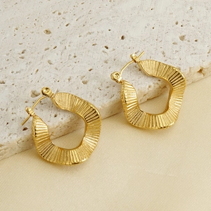 Detailed view of 18K gold plated rippled earrings on elegant silk and stone