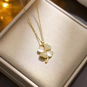 Sparkling gold four leaf clover necklace with crystal inlay on elegant jewelry box
