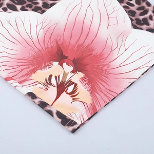 Detailed view showing floral leopard print fabric and double-needle stitching on mini dress