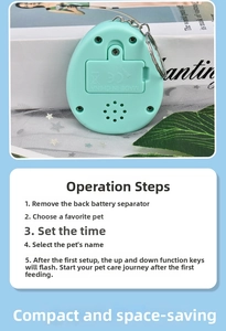 Detail view of mint green virtual pet device with silver keychain and battery compartment