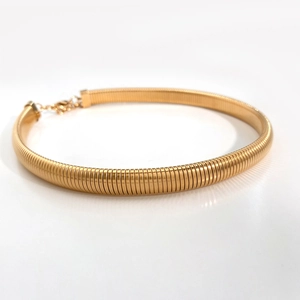 Close-up of gold spring snake chain choker with adjustable lobster clasp and extender