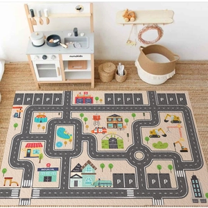 Children's city road play mat with parking lot and buildings in a cozy playroom