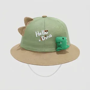 Detail of baby sun hat with mint green拼接 design and cute 3D dinosaur doll accessory