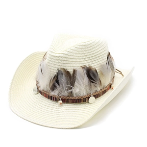 Detail of bohemian wide brim straw hat with ethnic feathers and decorative wood beads