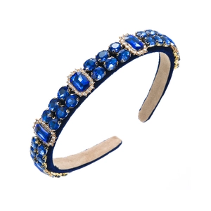 Close-up of baroque deep blue velvet headband with sparkling rhinestones and gems