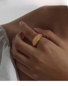 Detail showing gold plated titanium steel ring with sparkling pave crystals on wide band