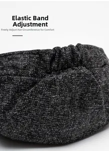 Detail of the elastic back band on a grey tweed beret for adjustable sizing and fit