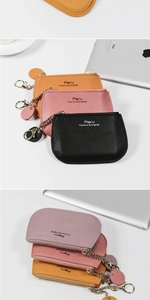 Close-up of textured PU leather coin purses with zipper and metal chain in assorted colors