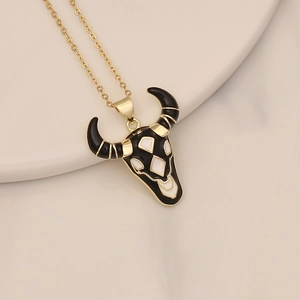 Detailed view of a gold-plated bull head pendant necklace with black enamel and zircon inlay