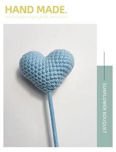 Detail of a handmade blue crochet heart flower with a knitted stem on a clean background