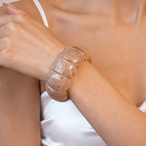 Macro detail of amber marble resin bracelet showing translucent texture and segment curves