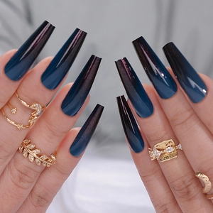 Close-up of long trapezoid nails with deep blue gradient design and glossy finish