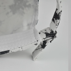 Detail of adjustable metal buckle and tie-dye cotton fabric on the back of the sun hat