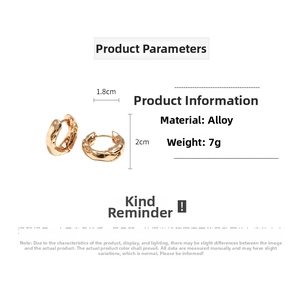 Detail view of gold textured round hoop earrings with 1.8cm by 2.0cm size dimensions