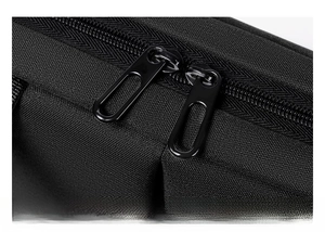 Detail of smooth metal double zippers and high-density black nylon fabric on laptop bag