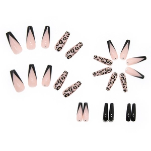 Detail of long French press-on nails with leopard print and sparkling rhinestones
