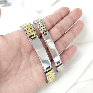 Close-up of dual-tone stainless steel ID bracelets with rectangle blank plates